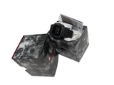 Black digital watch in a gray textured box on a white surface